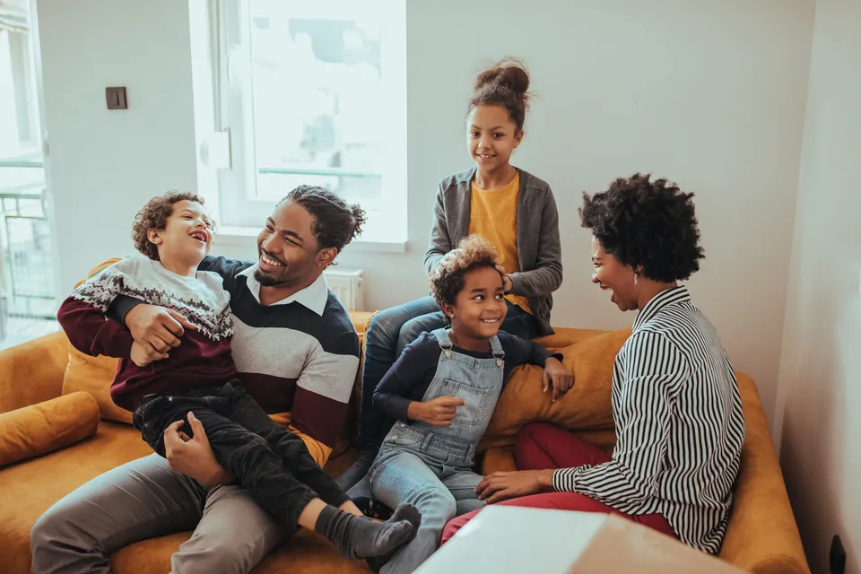 large family in living room of apartment building home