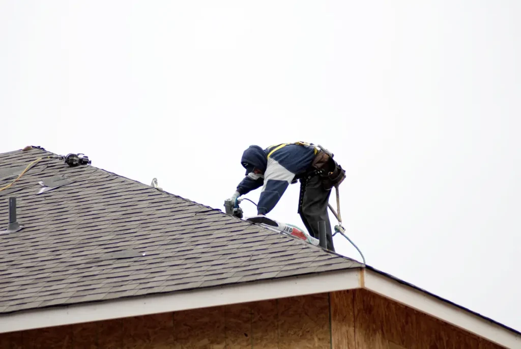 roofer installing shingles