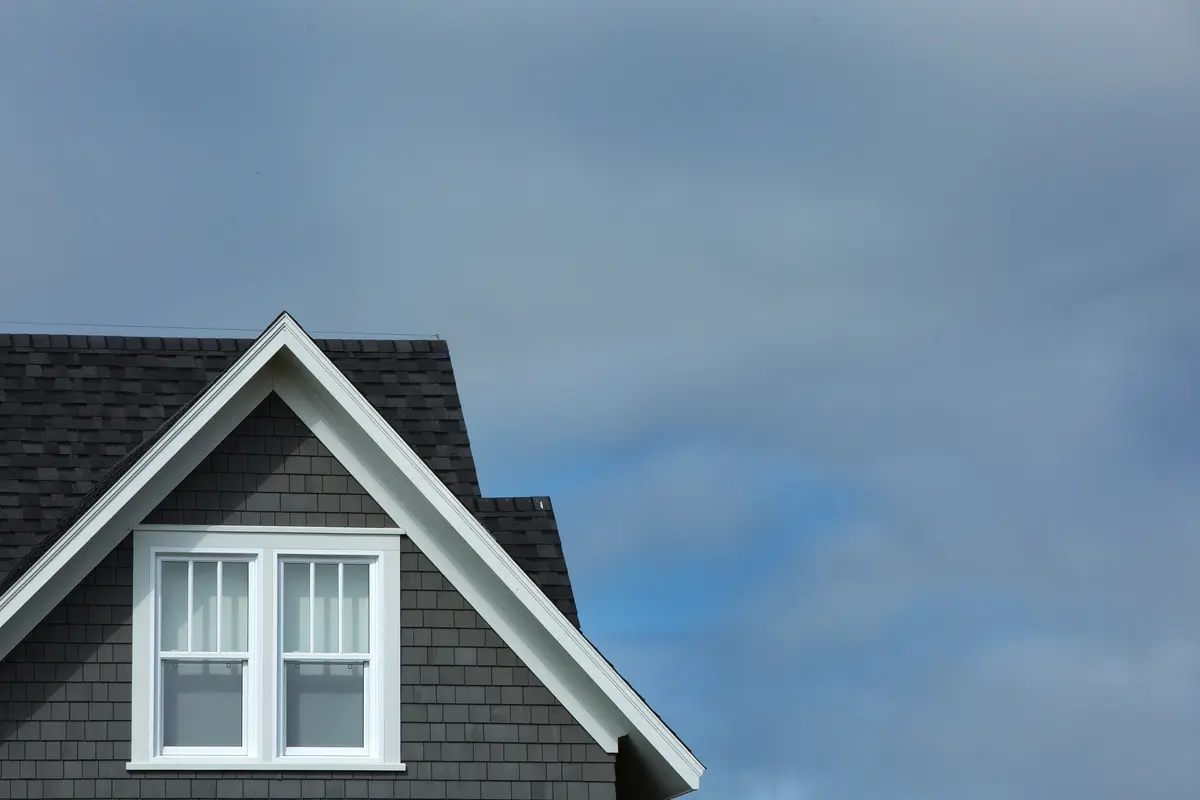 peak of a roof and gloomy sky
