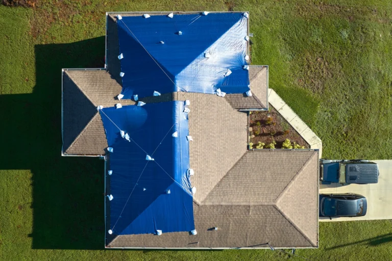 house roof with secured tarp - how to tarp a roof